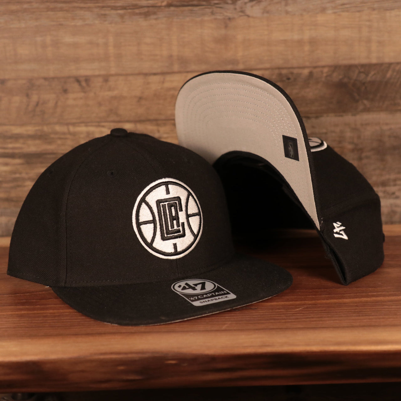 front and bottom of the Los Angeles Clippers Black Adjustable Grey Bottom Snapback Hat