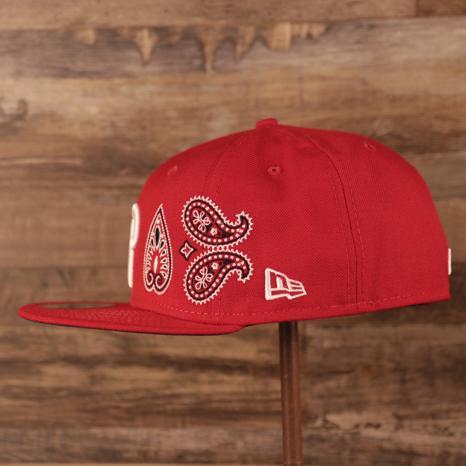 Wearer's left of the Philadelphia Phillies Paisley Elements Bandana Retro Green Bottom 59Fifty Fitted Cap