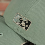 Milb batterman logo on the Memphis Chicks Hometown Roots Two Tone Grey Bottom Light Sage/Sand 59Fifty Fitted Cap