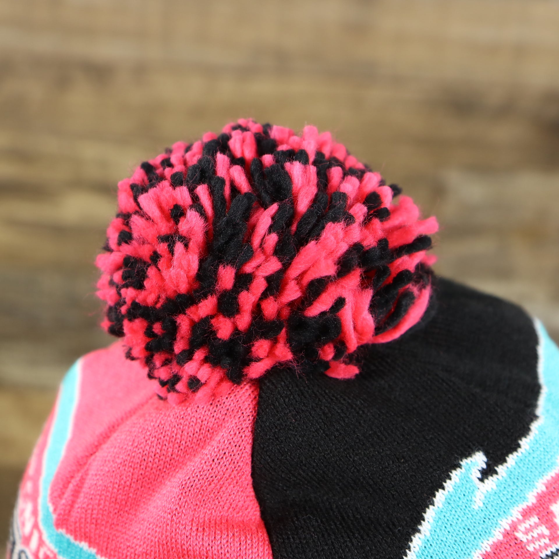 The Pom Pom on the San Antonio Spurs Retro Logo Two Sided Cuffed Winter Beanie | Pink And Black Winter Beanie