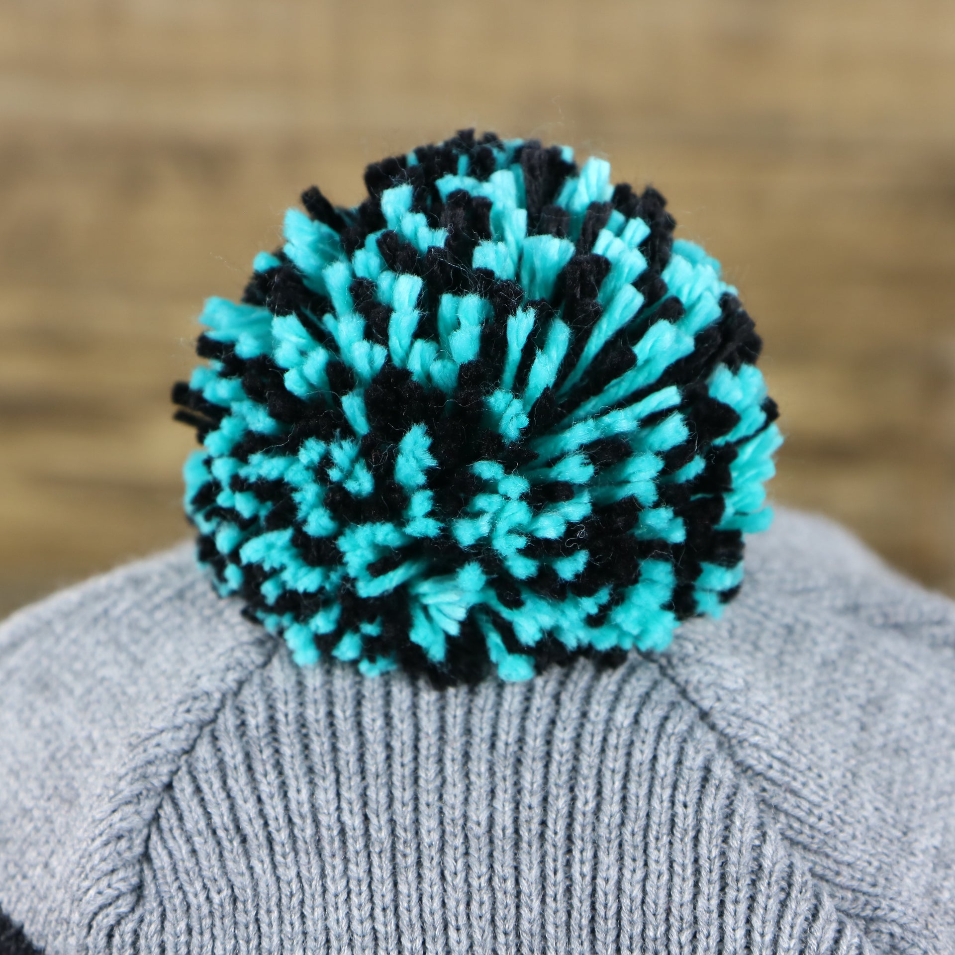 The Pom Pom on the Retro San Antonio Spurs Striped Wordmark Cuffed Pom Pom Beanie | Gray And Black Winter Beanie