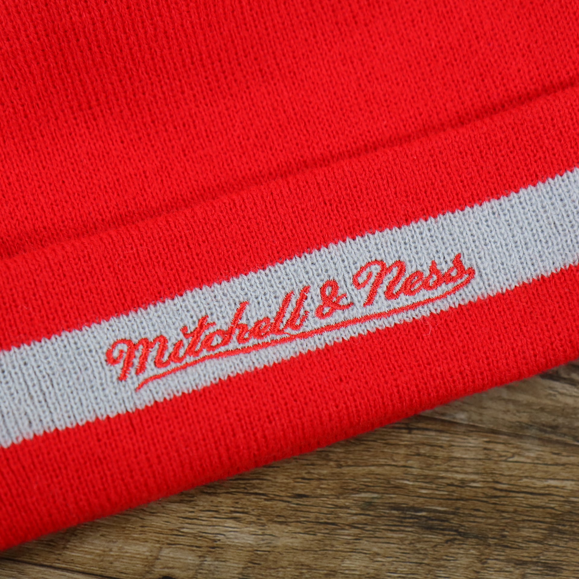 The Mitchell And Ness Script Logo on the Houston Rockets Vintage Red & Gray Beanie OSFM