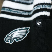 The 47 brand Tag on the Kid’s Philadelphia Eagles Striped Pom Pom Winter Beanie | Black, Midnight Green, And White Beanie