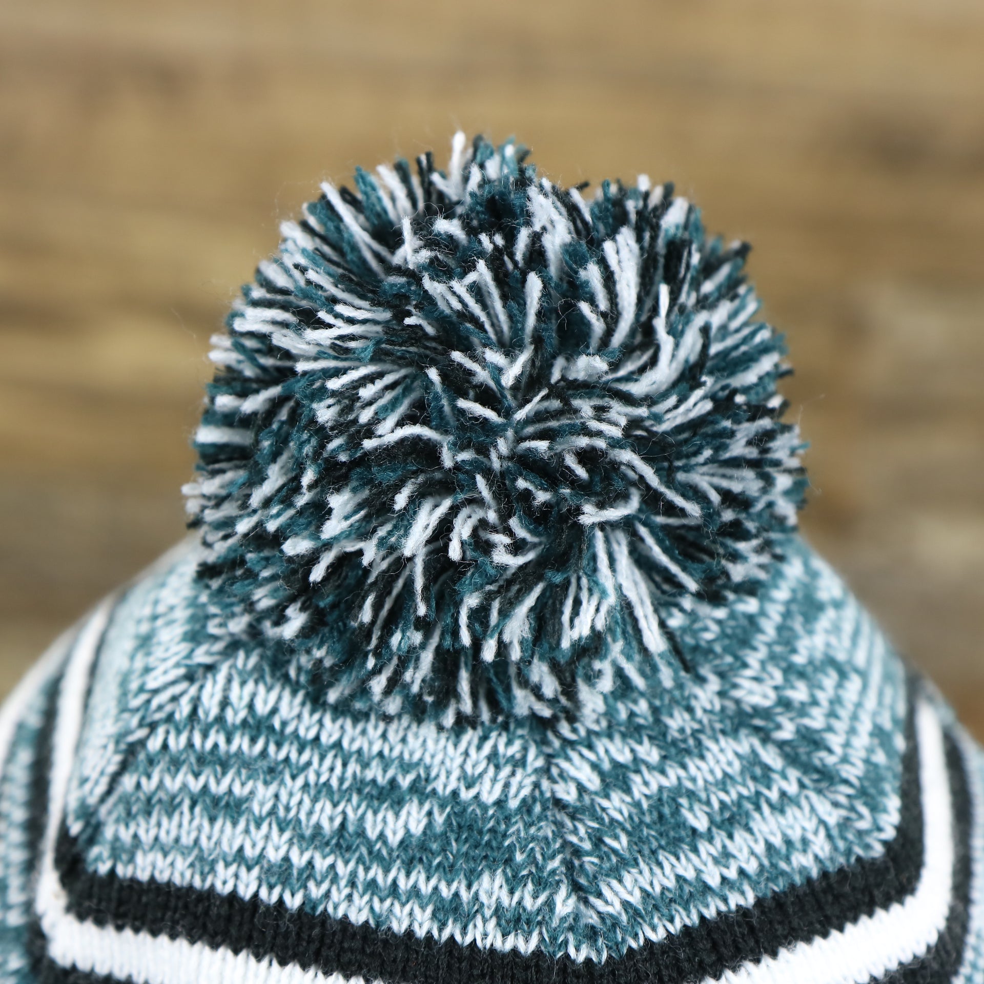 The Multi Colored Pom Pom on the Kid’s Philadelphia Eagles Striped Pom Pom Winter Beanie | Black, Midnight Green, And White Beanie