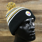 The Kid’s Pittsburgh Steelers Striped Pom Pom Winter Beanie | Black, Yellow, And White Beanie on a doll
