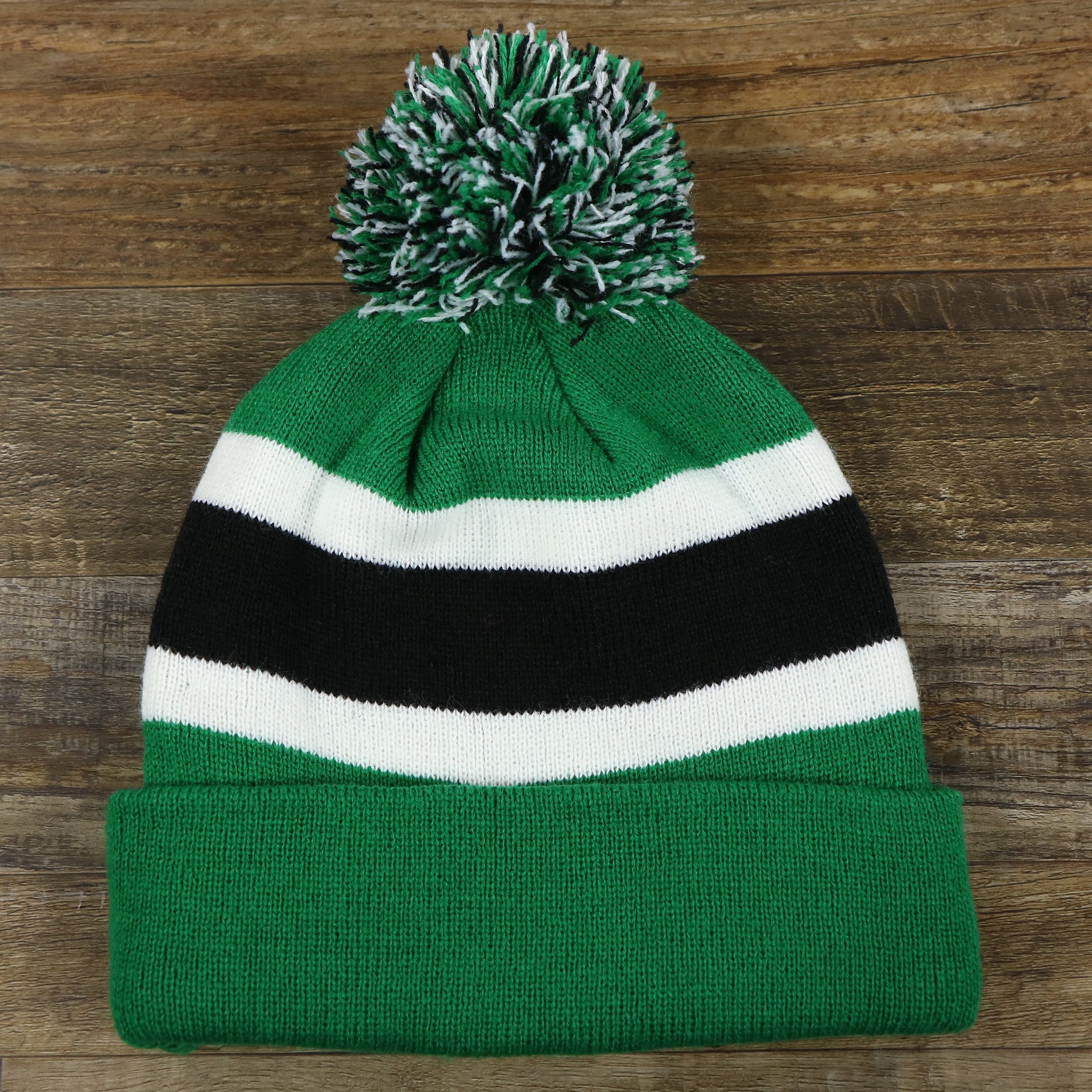 The backside of the Legacy Philadelphia Eagles Cuffed Logo Striped Winter Beanie With Pom Pom | Kelly Green Winter Beanie