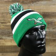 The Legacy Philadelphia Eagles Cuffed Logo Striped Winter Beanie With Pom Pom | Kelly Green Winter Beanie on a doll