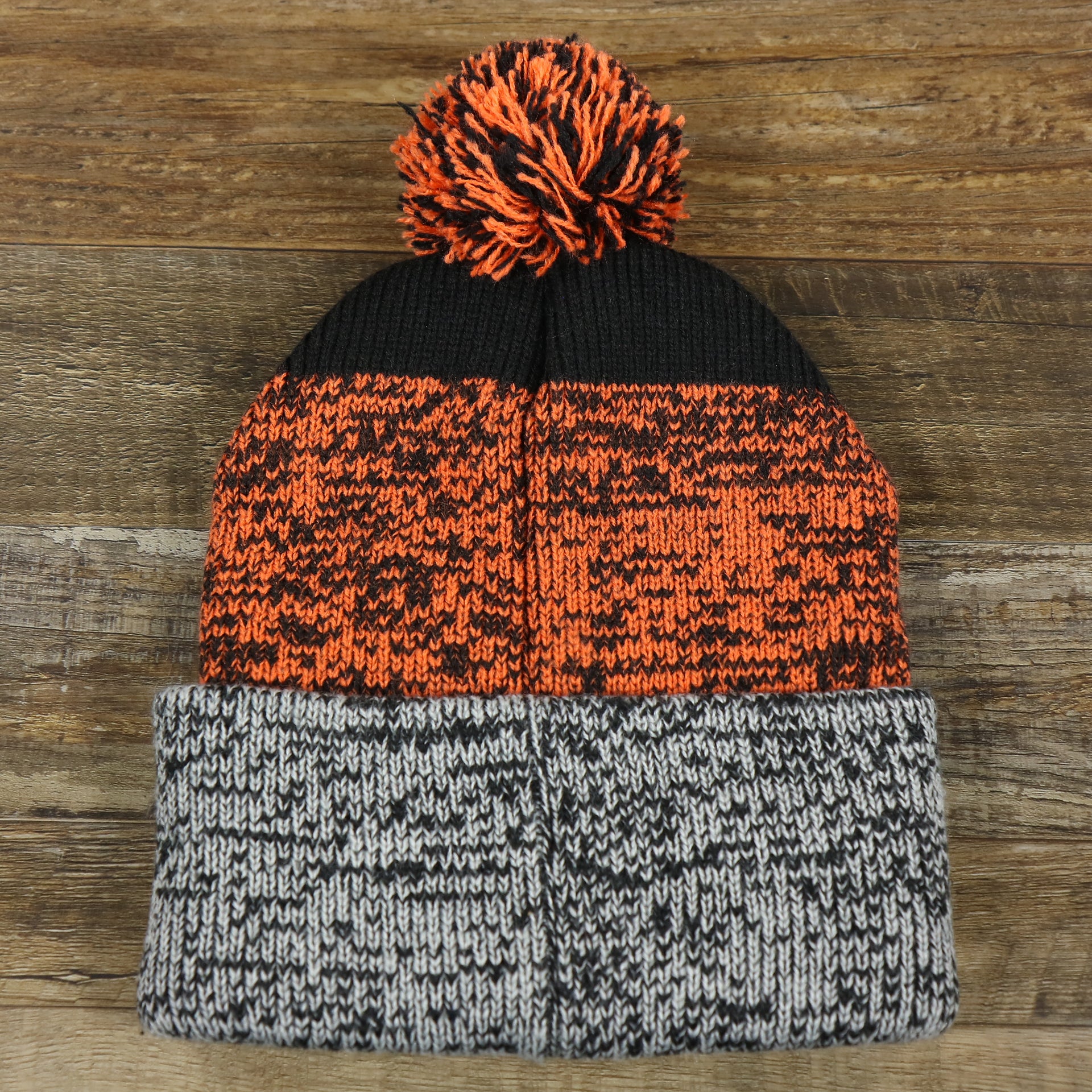 The backside of the Philadelphia Flyers Static Knit Cuffed Winter Beanie With Pom Pom | Black, Orange, And Gray Beanie