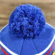 The Pom Pom on the DC Comics Superman S-Shield Logo Superman Wordmark Striped Beanie With Blue Pom Pom | Blue And Red Winter Beanie