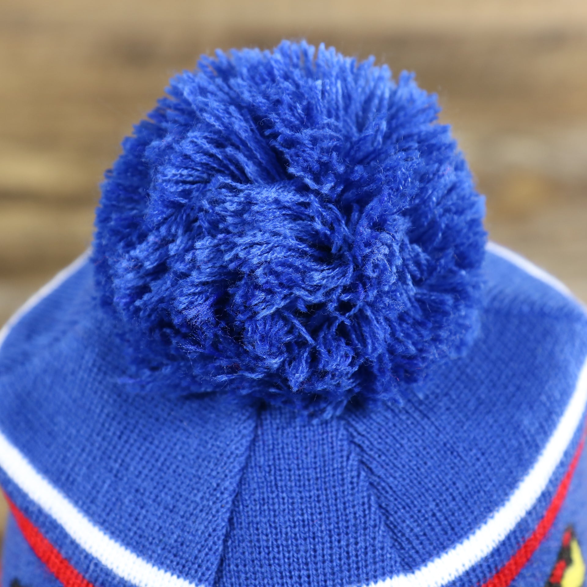 The Pom Pom on the DC Comics Superman S-Shield Logo Superman Wordmark Striped Beanie With Blue Pom Pom | Blue And Red Winter Beanie