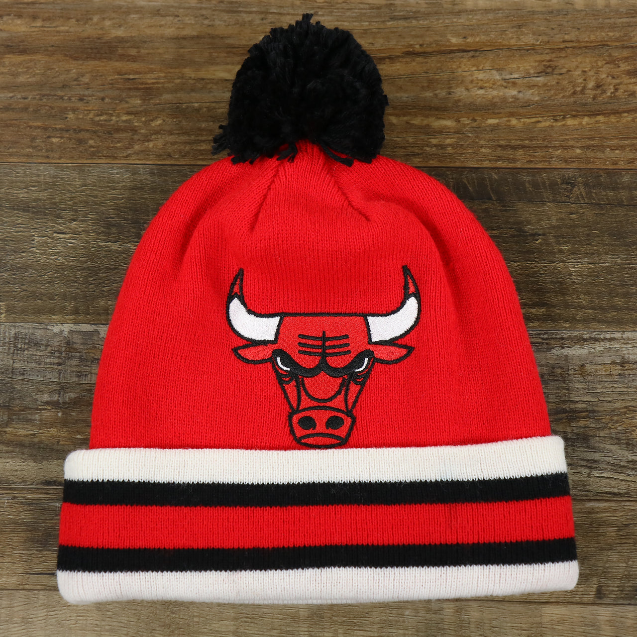 The front of the Chicago Bulls Striped Cuff Pom Pom Winter Beanie | Red Winter Beanie