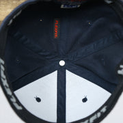 The inside of the Jet Black Bent Brim Silver Bottom Blank FlexFit Cap | Black Flex Cap