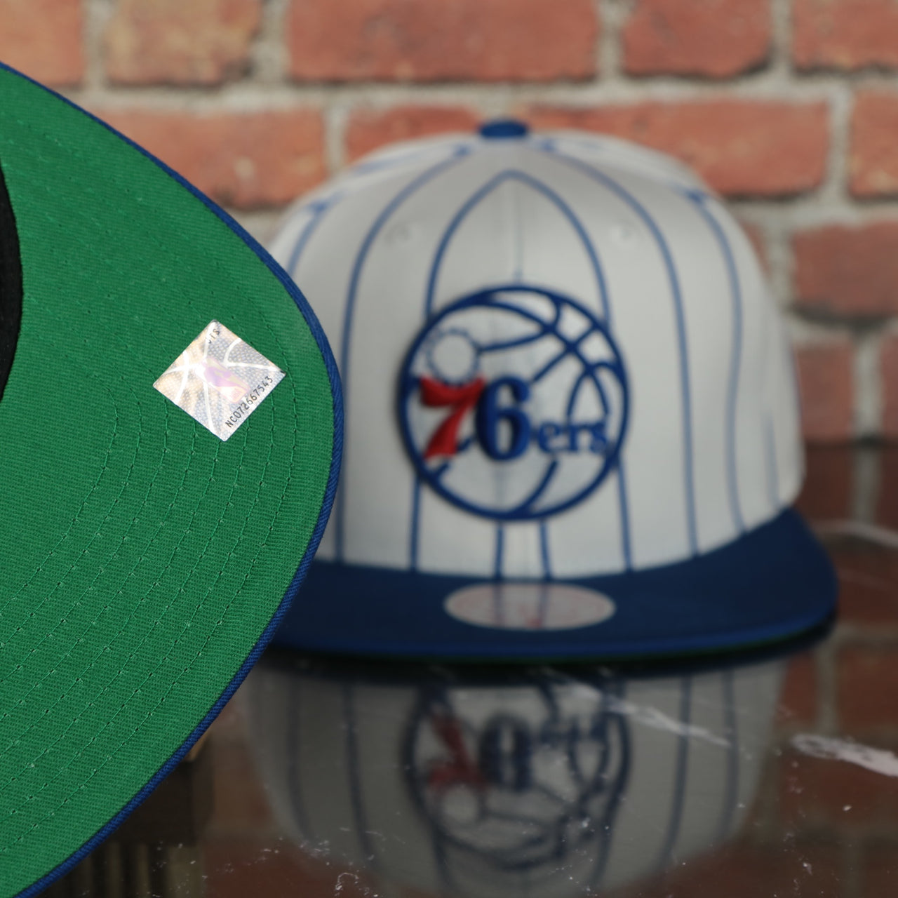 green under visor on the Philadelphia 76ers Vintage Pinstripe Baseball Hat | Retro Mitchell and Ness White Pinstripe Snapback Hat