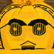 The C3PO Print on the C3PO Rebel Alliance Cuffed Logo Winter Beanie With Pom Pom | Yellow Winter Beanie
