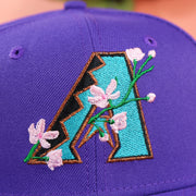 The Cooperstown Diamondbacks Sakura Logo on the Cooperstown Arizona Diamondbacks Pink Undervisor Sakura Tree Embroidered 59Fifty Fitted Cap | Purple 59Fifty Cap