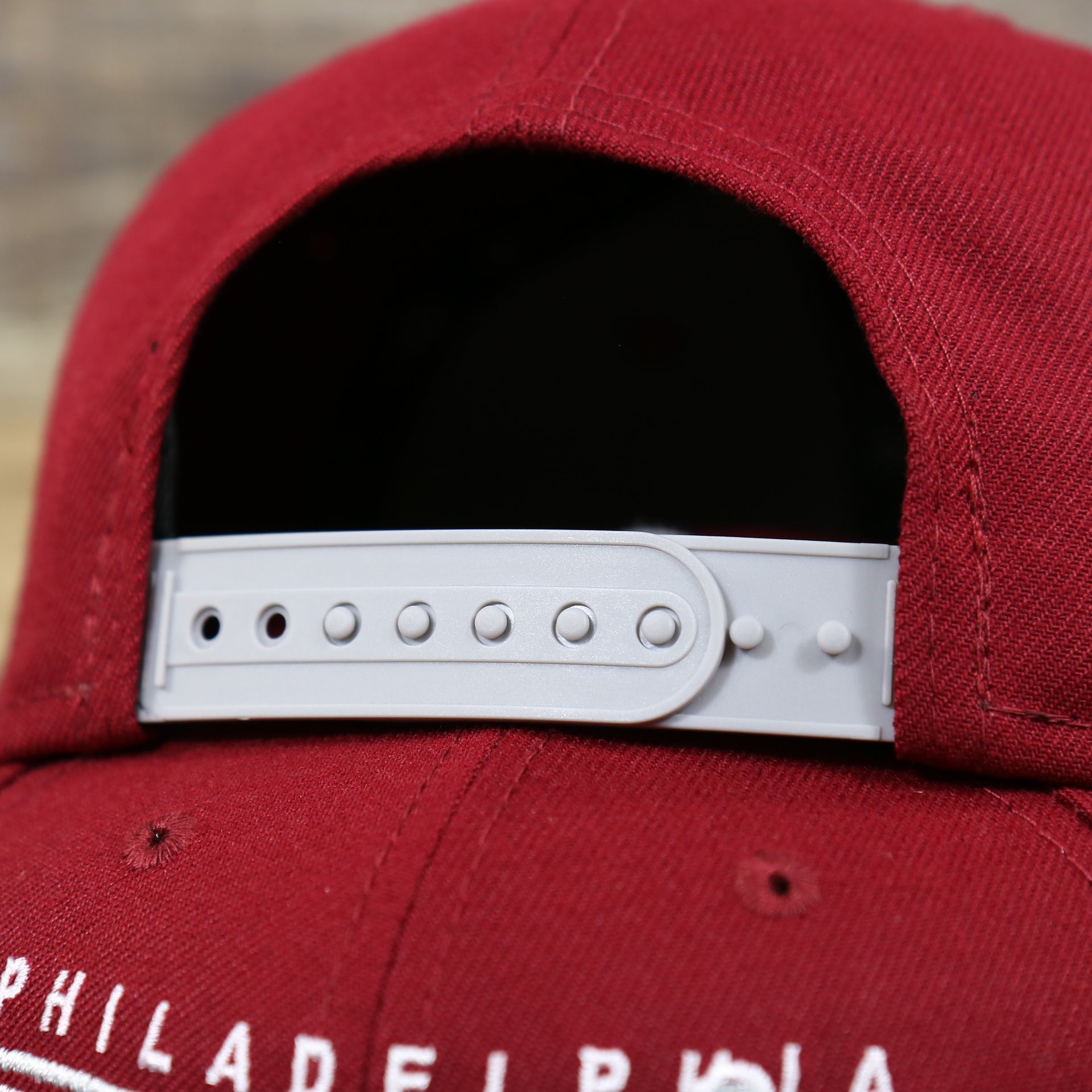 The Grey Adjustable Strap on the Philadelphia Phillies Team Script Gray Bottom 9Fifty Snapback | Maroon And Grey Snap Cap