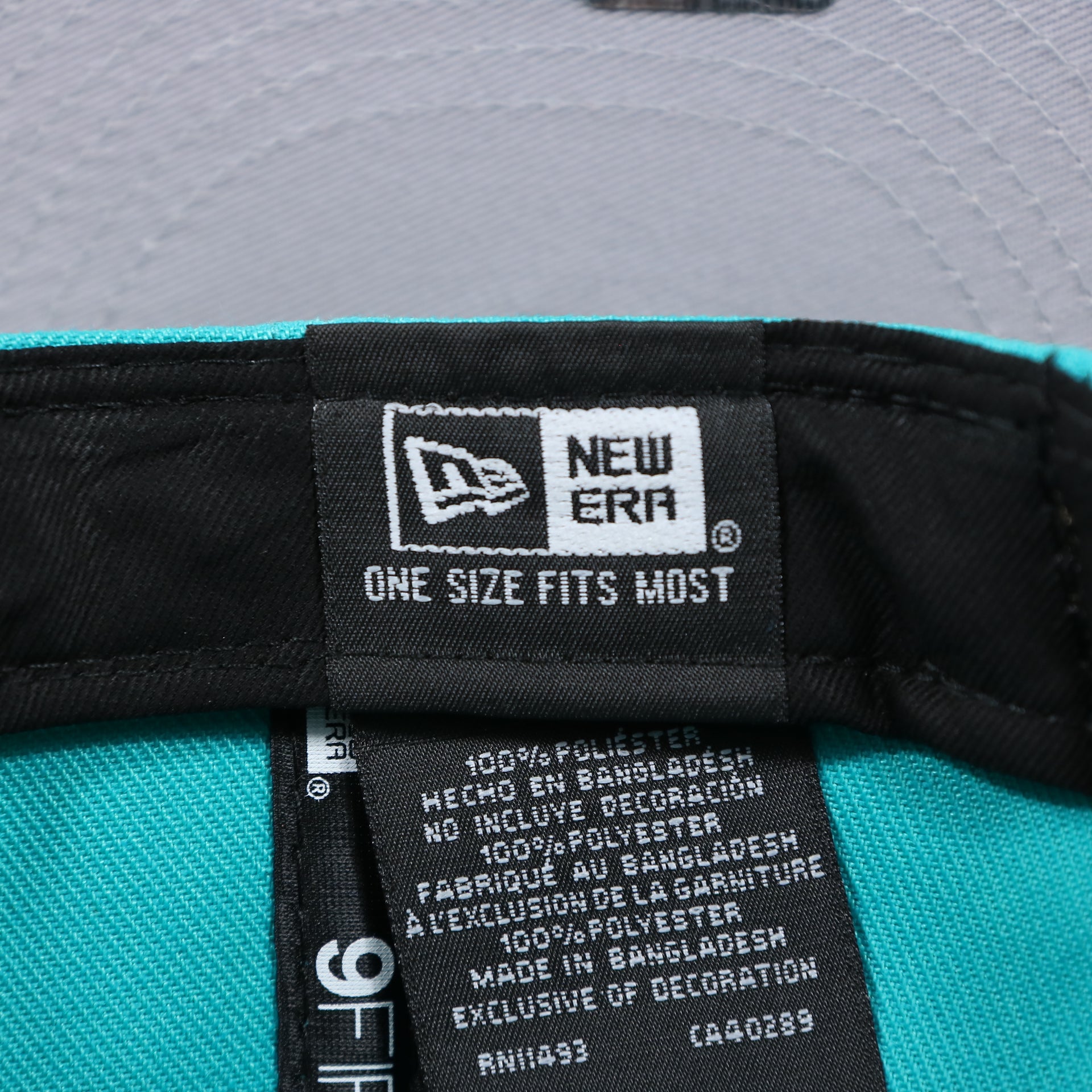 The New Era Tag on the Miami Dolphins Team Script Gray Bottom 9Fifty Snapback | Aqua and Orange Snap Cap