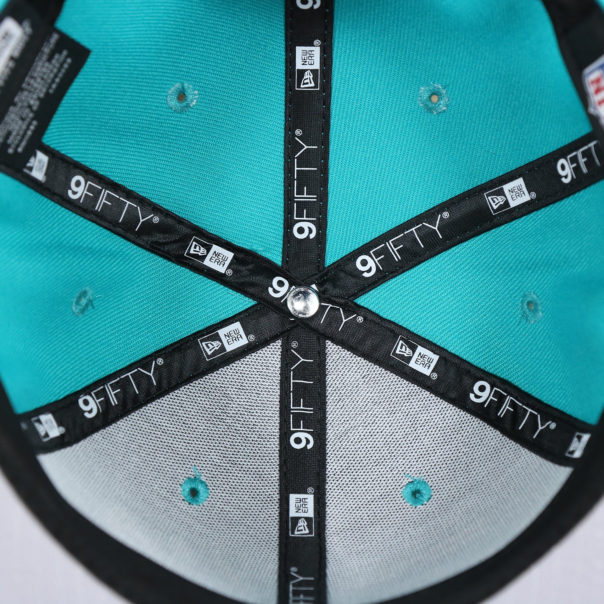 The inside of the Miami Dolphins Team Script Gray Bottom 9Fifty Snapback | Aqua and Orange Snap Cap