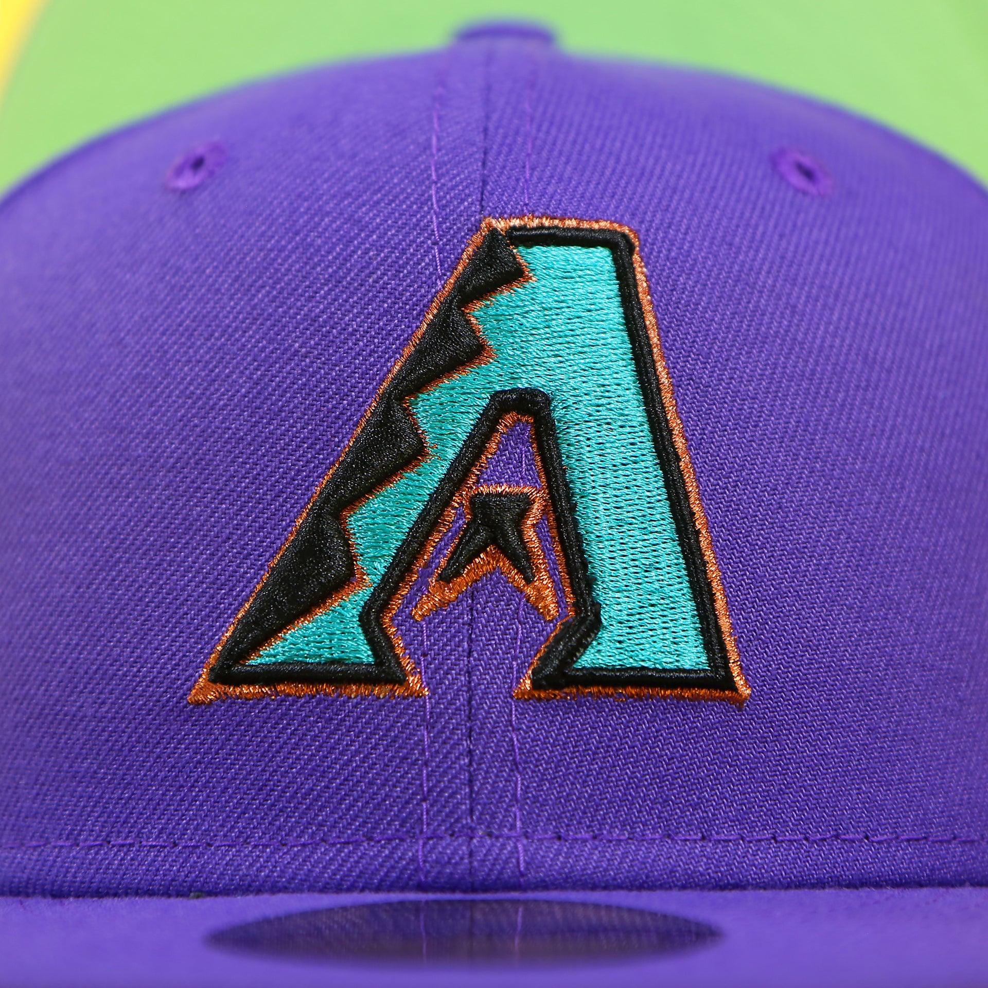 Close up of the Arizona Diamondbacks logo on the Arizona Diamondbacks Cooperstown 2001 World Series Side Patch "Citrus Pop" Green UV 59Fifty Fitted Cap