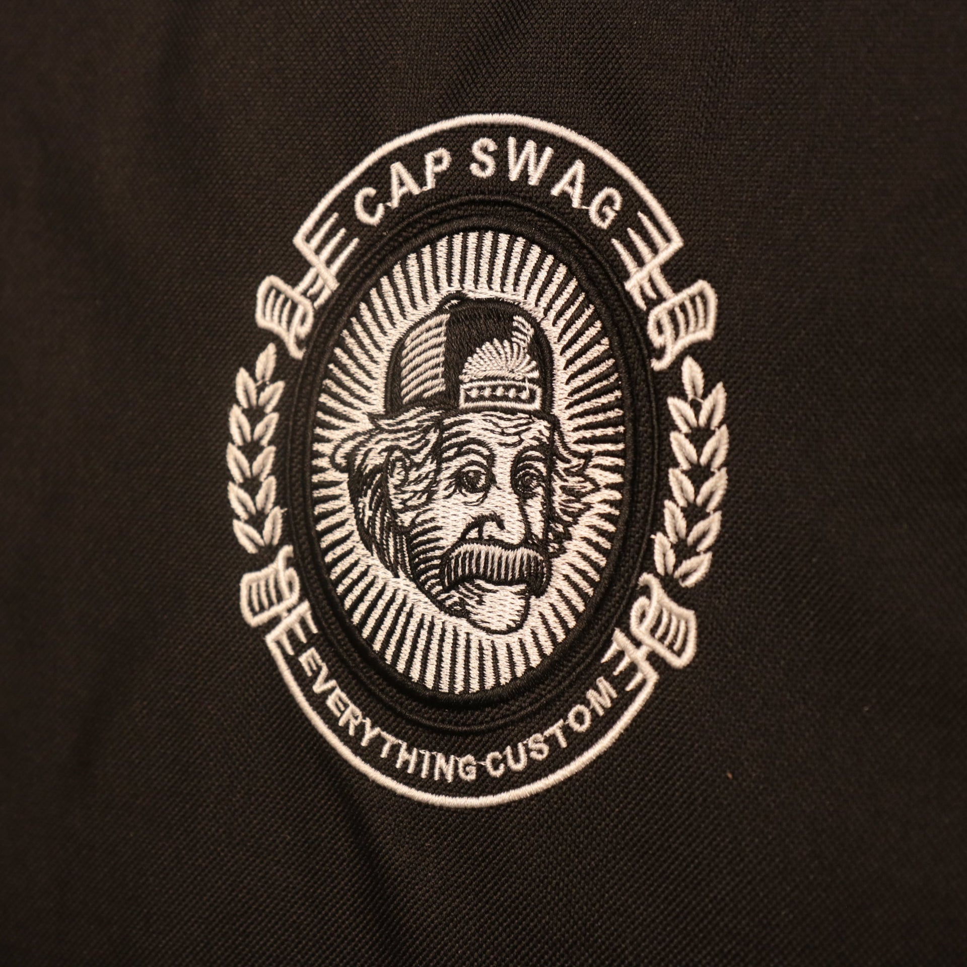 Close up of the embroidered logo on the 24 Pack Cap Carrier | Portable Cap Storage and Cap Travel Bag