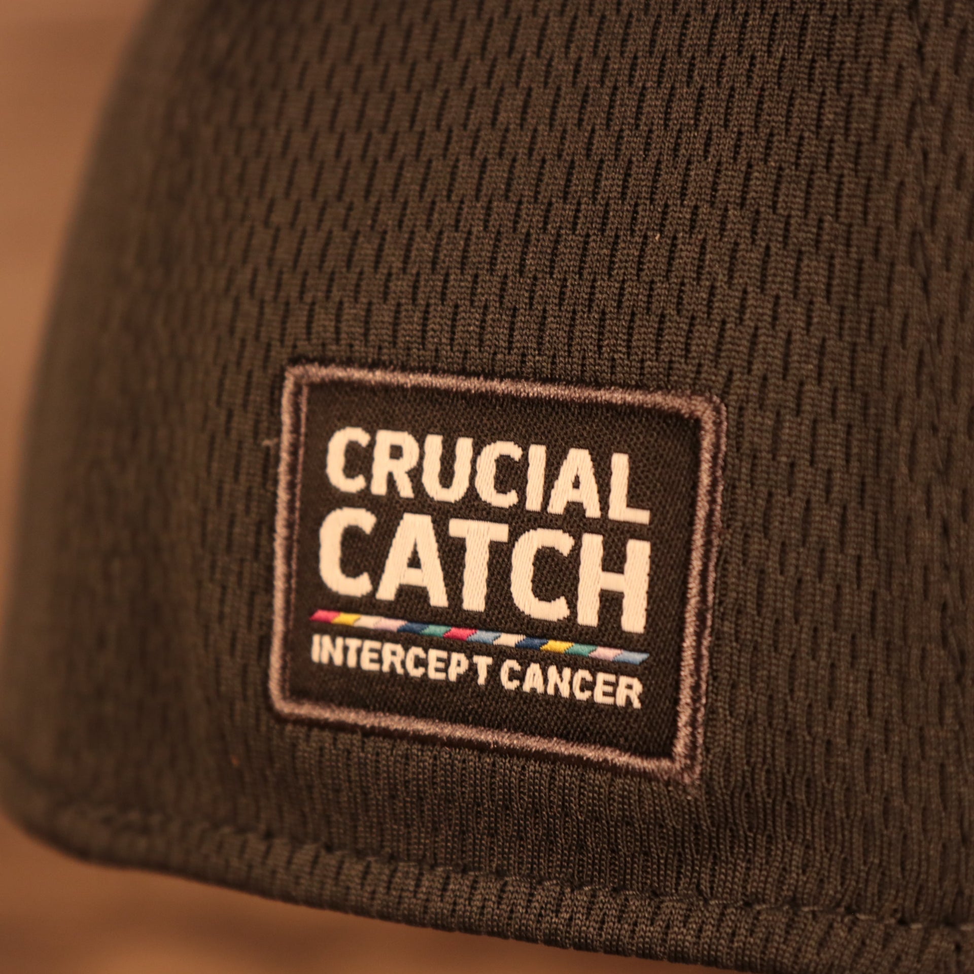 Close up of side patch on the Philadelphia Eagles NFL 2021 Crucial Catch Cancer Awareness 39Thirty Stretch Fit Cap