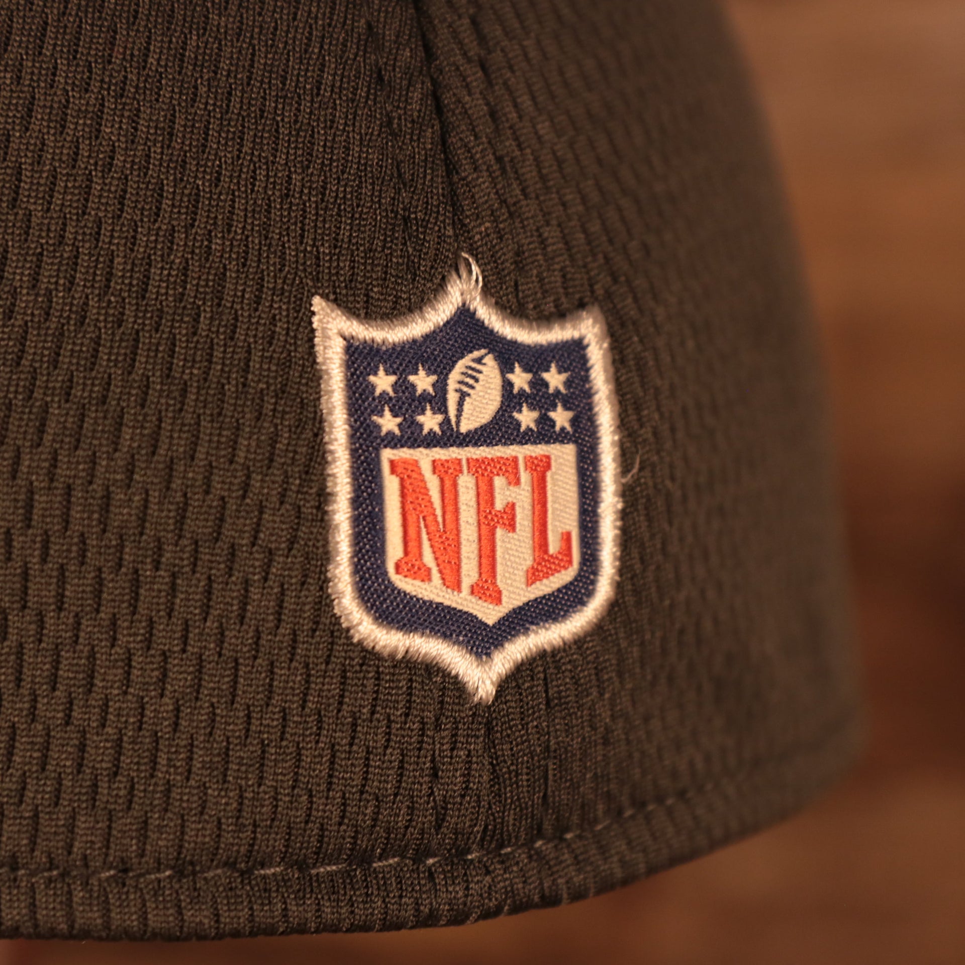 Close up of the NFL shield on the back of the Philadelphia Eagles NFL 2021 Crucial Catch Cancer Awareness 39Thirty Stretch Fit Cap