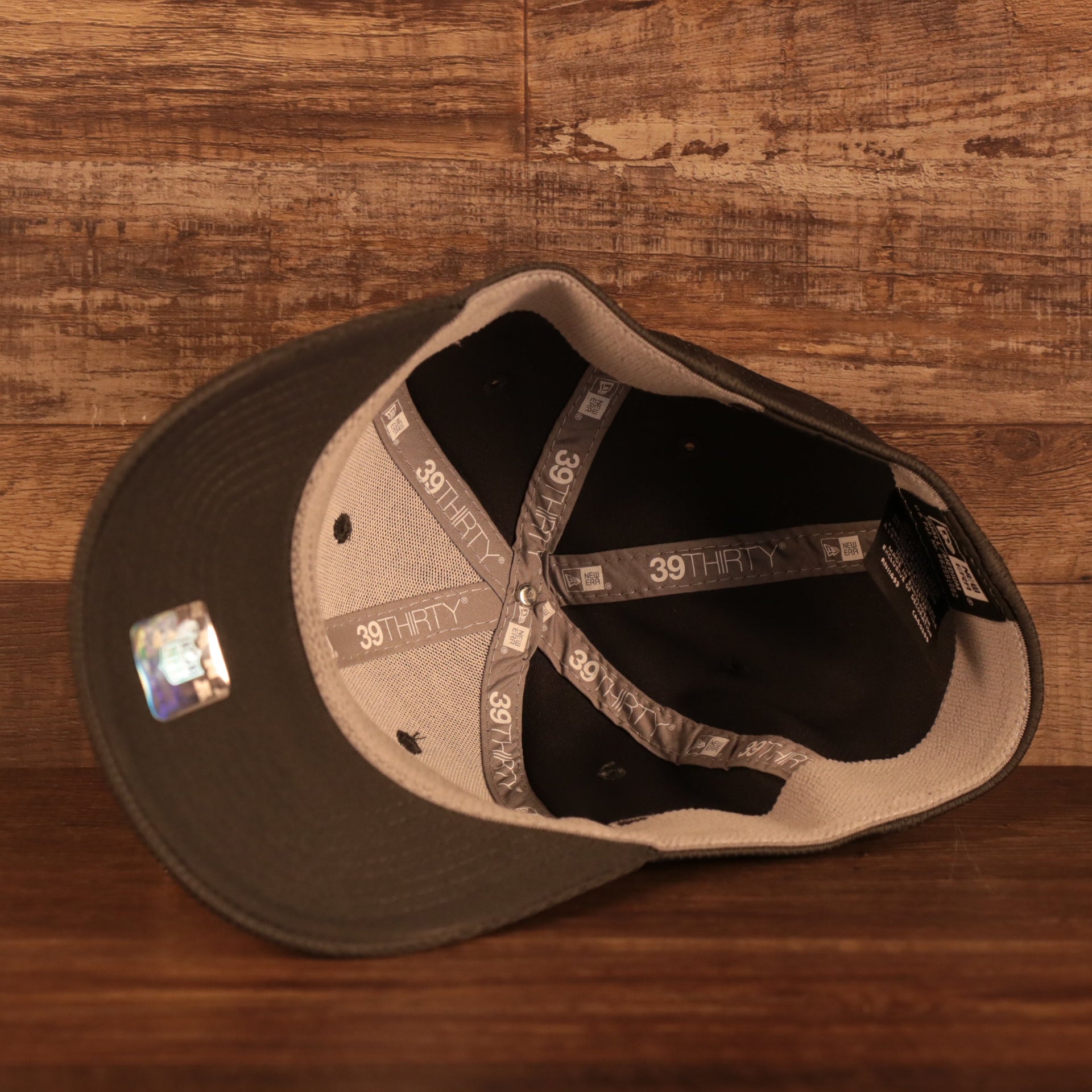 Dark gray under visor on the Philadelphia Eagles NFL 2021 Crucial Catch Cancer Awareness 39Thirty Stretch Fit Cap