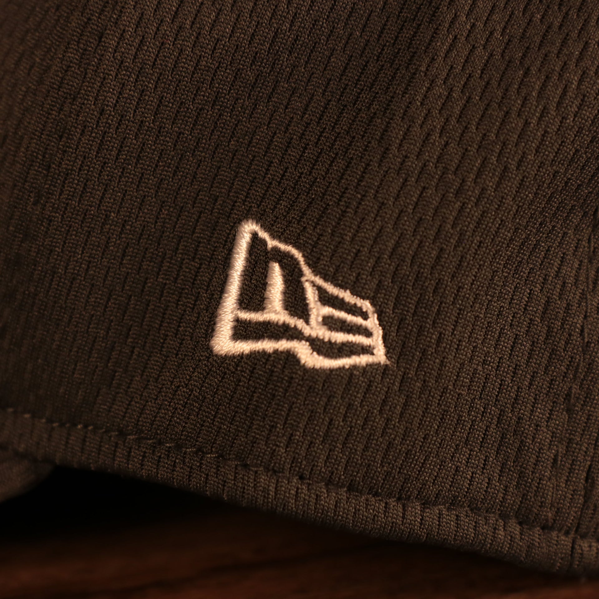 Close up of the New Era logo on the Pittsburgh Steelers NFL 2021 Crucial Catch Cancer Awareness 39Thirty Stretch Fit Cap