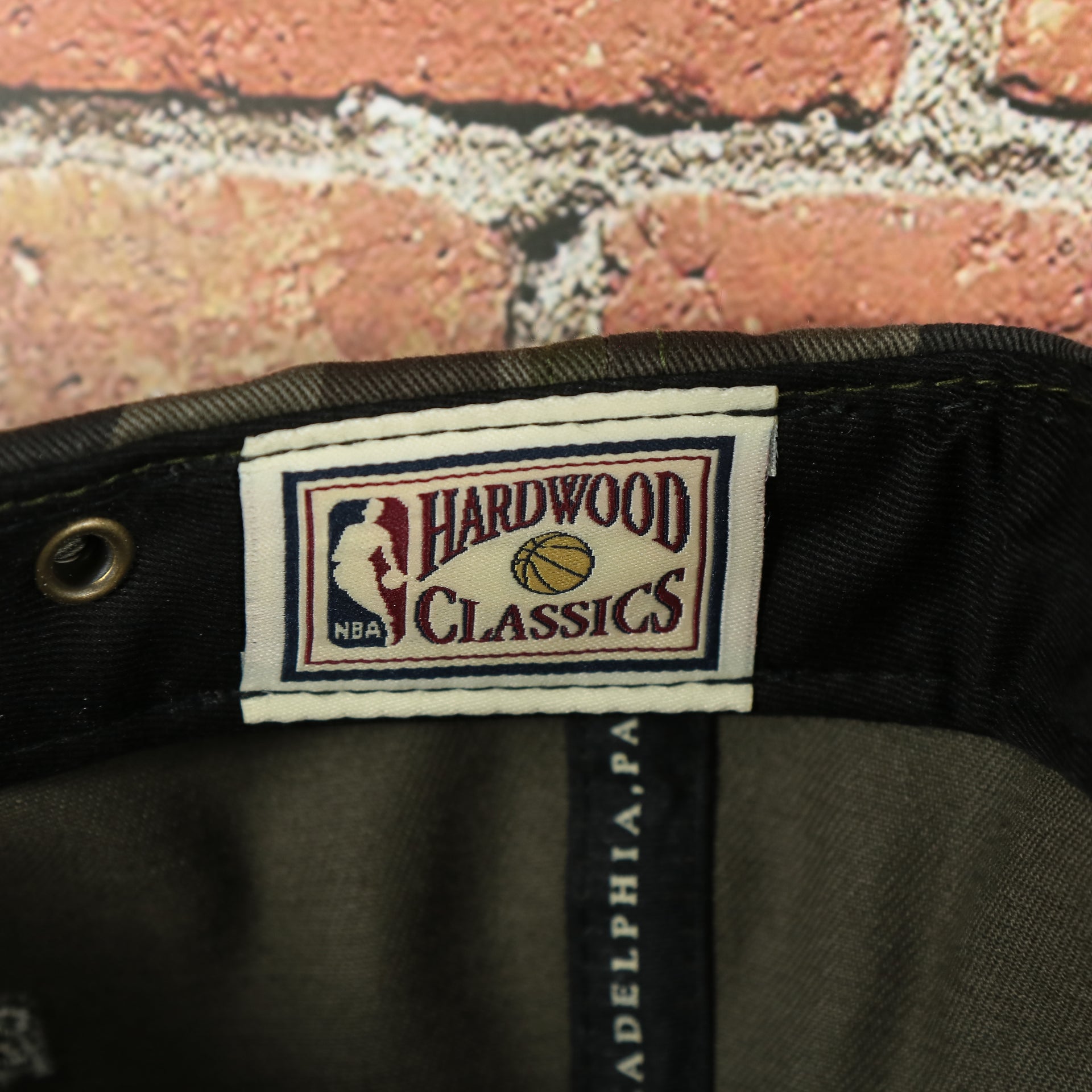 hardwood classic label on the Los Angeles Clippers Woodland Camouflage Mitchell and Ness Dad Hat