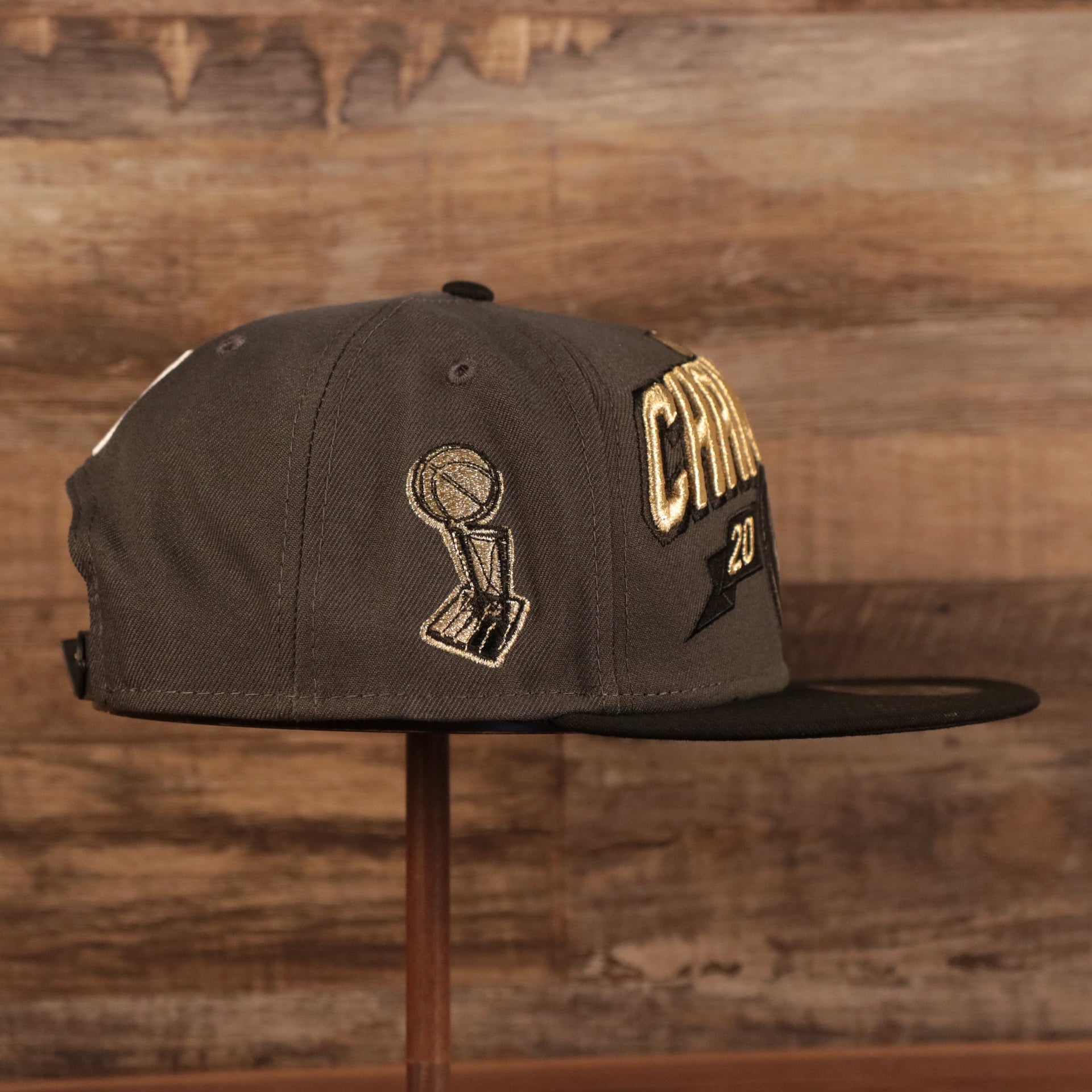 On the wearer's right of the 2021 NBA Champions Milwaukee Bucks 9Fifty Champ Hat is the Larry O'Brien trophy embroidered in metallic gold and black