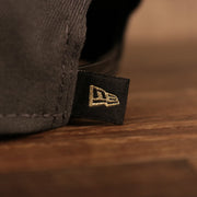 A close up of the New Era flag on the back of the Milwaukee Bucks 2021 NBA Champions Trophy Locker Room 9Fifty Snapback Hat