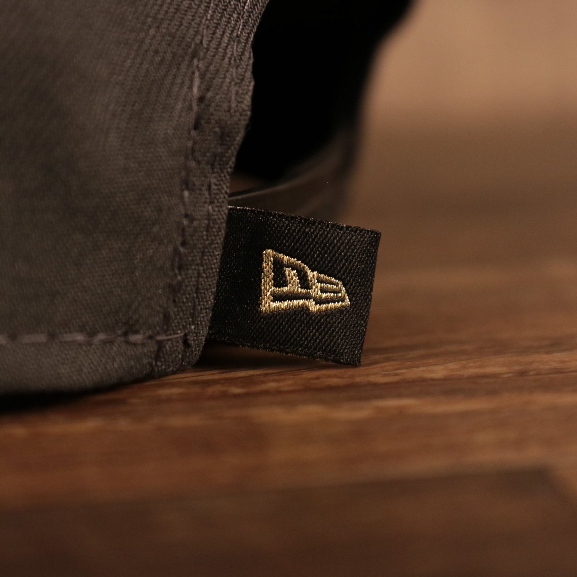 A close up of the New Era flag on the back of the Milwaukee Bucks 2021 NBA Champions Trophy Locker Room 9Fifty Snapback Hat