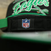 NFL label on the Philadelphia Eagles Vintage Team Script College Bar Gray Bottom 9Fifty Snapback | Black/Kelly Green Birds 950 Snap Cap