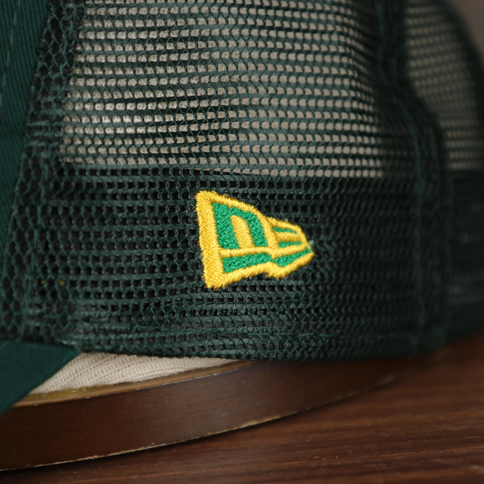 Close up of the New Era logo on the Oakland Athletics 2022 MLB Batting Practice On-Field Spring Training 9Twenty Trucker Dad Hat