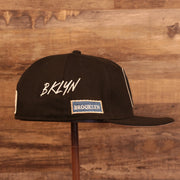 Wearer's right side of the Brooklyn Nets City Transit All Over Side Patch Gray Bottom 59Fifty Fitted Cap