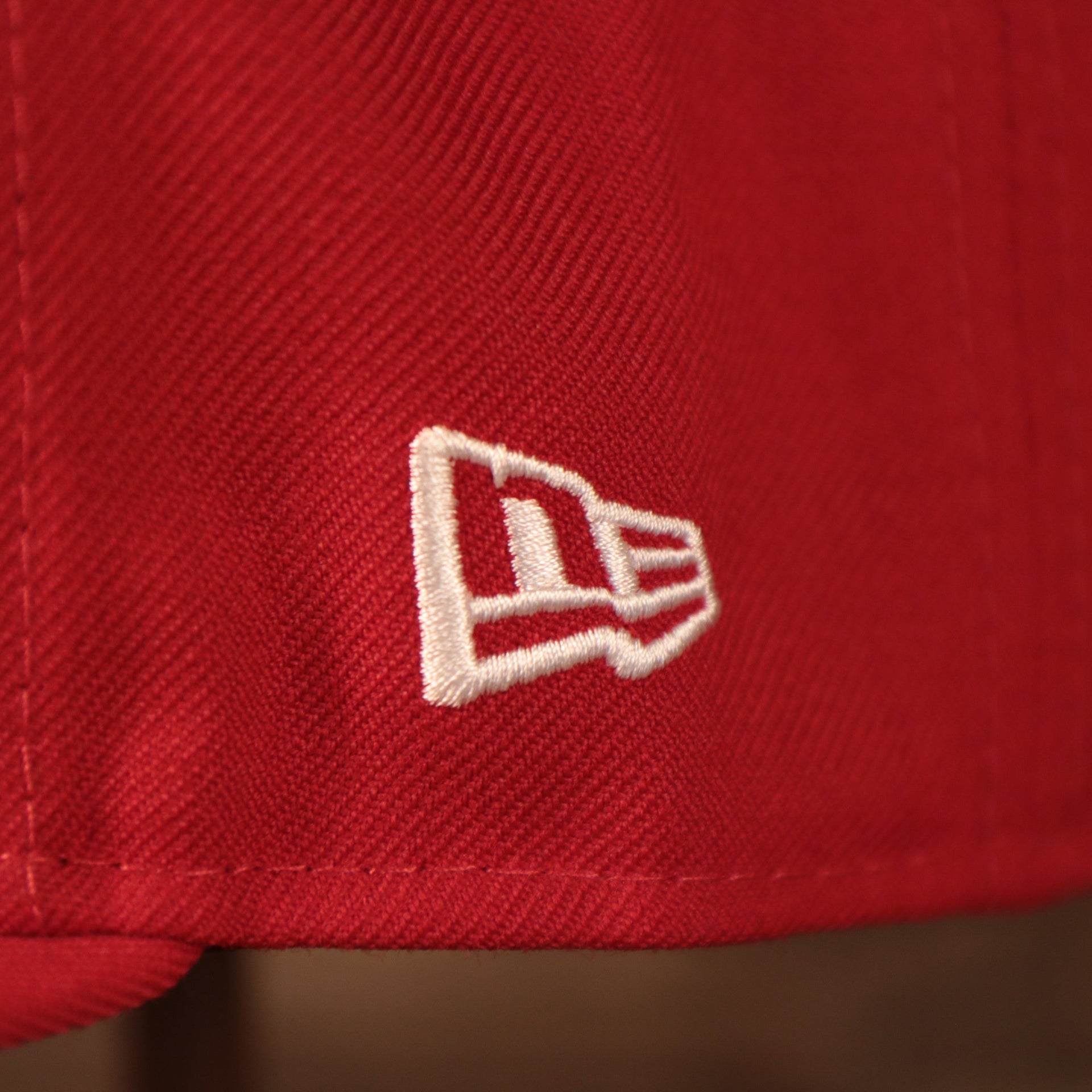Close up of the New Era logo on the Philadelphia Phillies 1996 All Star Game Crystal Side Patch Icy Blue Bottom 59Fifty Fitted Cap