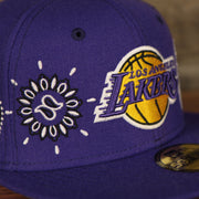 lakers logo on the Los Angeles Lakers All Over Paisley Bandana Pattern Grey Bottom 5950 Fitted Cap | Purple