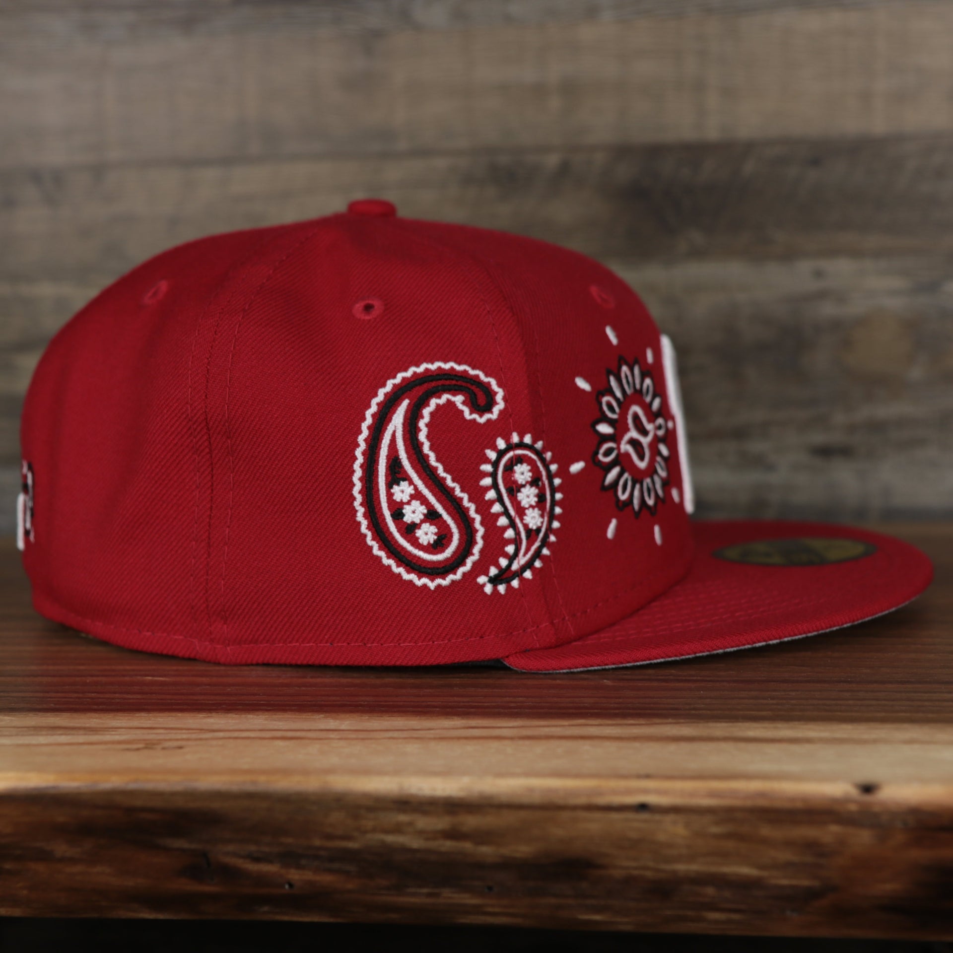 wearers right of the Philadelphia Phillies All Over Paisley Bandana Pattern Grey Bottom Red 5950 Fitted Cap | Bandana Paisley