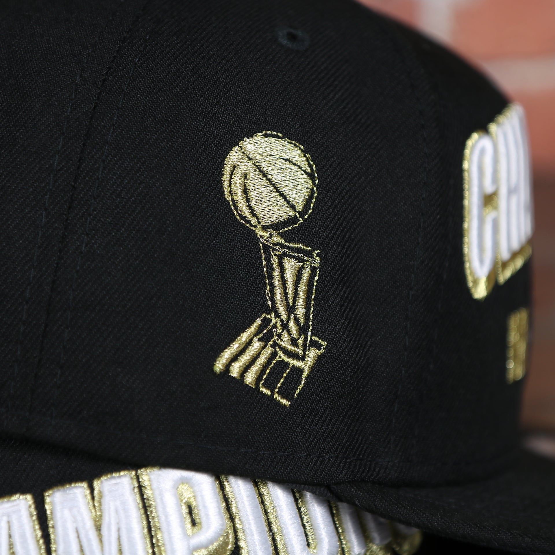 trophy embroidery on the Men's Toronto Raptors New Era Black 2019 NBA Finals On Court Champions Locker Room 9FIFTY Snapback Hat