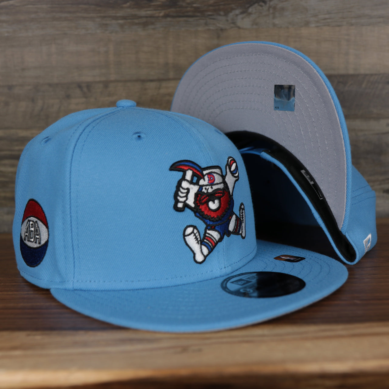 front and bottom of the Denver Nuggets 2021 City Edition Vintage Grey Bottom 9Fifty Snapback | Light Blue