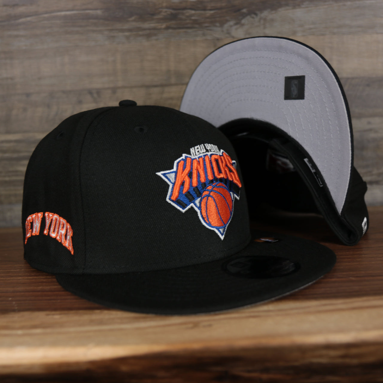 front and bottom of the New York Knicks 2021 City Edition Vintage Grey Bottom 9Fifty Snapback | Black