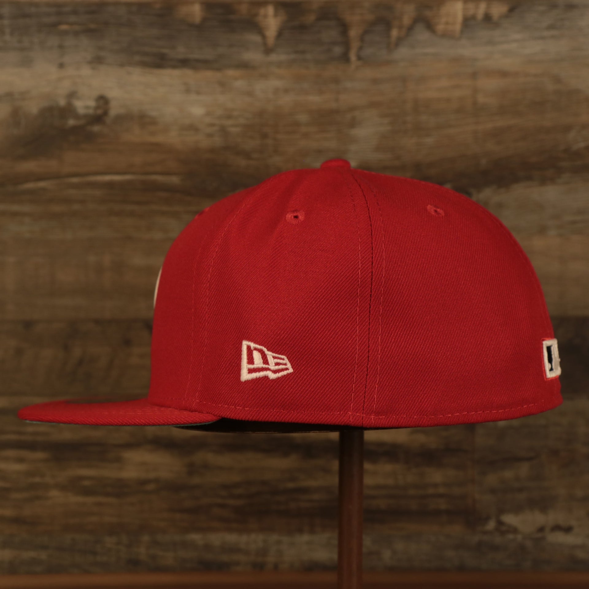 Wearer's left of the Philadelphia Phillies Glow In The Dark 100th Anniversary Teal Bottom Side Patch 59Fifty Fitted Cap