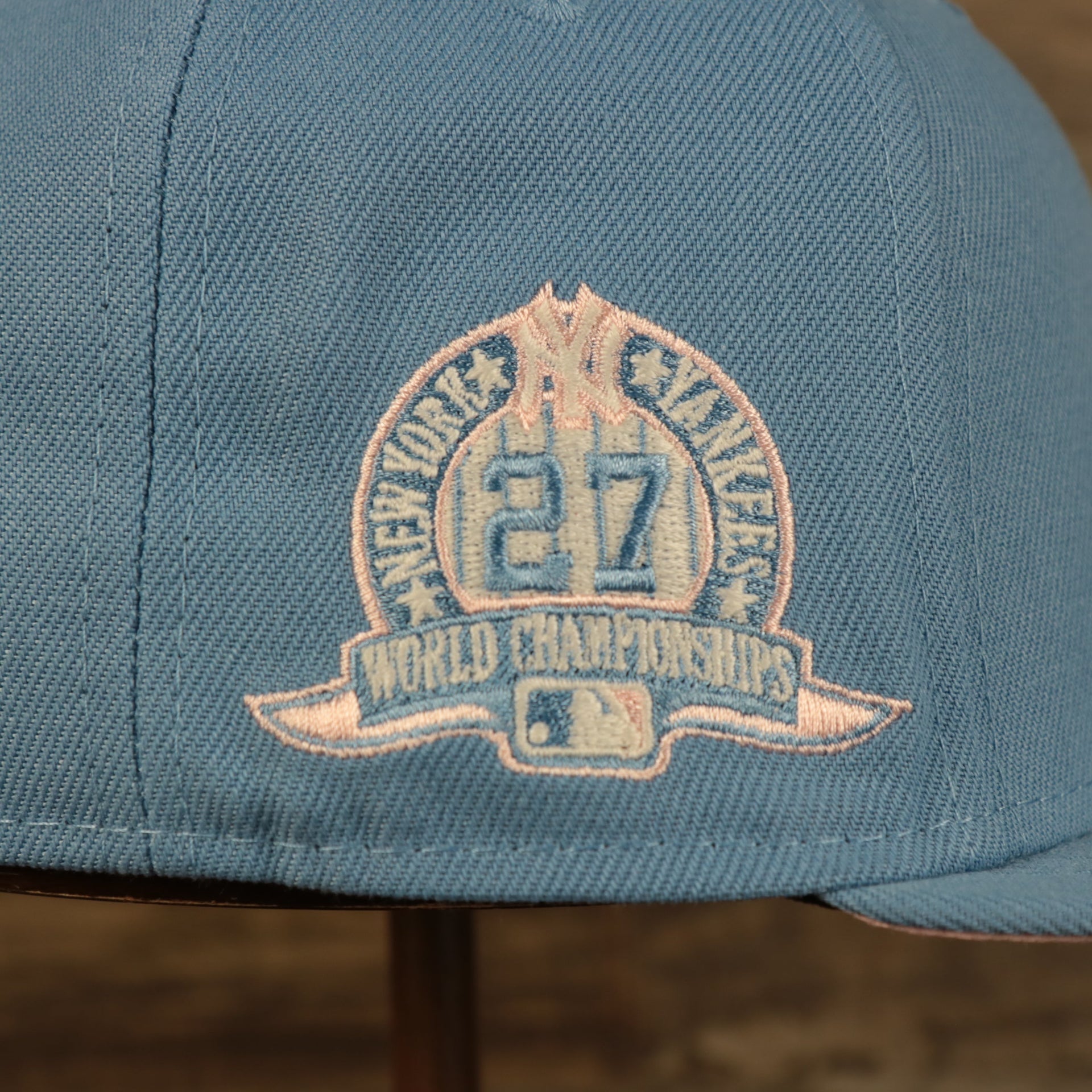 Close up of the 27X World Champions side patch on the New York Yankees Glow In The Dark 27x World Series Champs Patch Pink Bottom Side Patch 59Fifty Fitted Cap