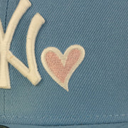 Close up of the heart embroidery on the New York Yankees Glow In The Dark 27x World Series Champs Patch Pink Bottom Side Patch 59Fifty Fitted Cap