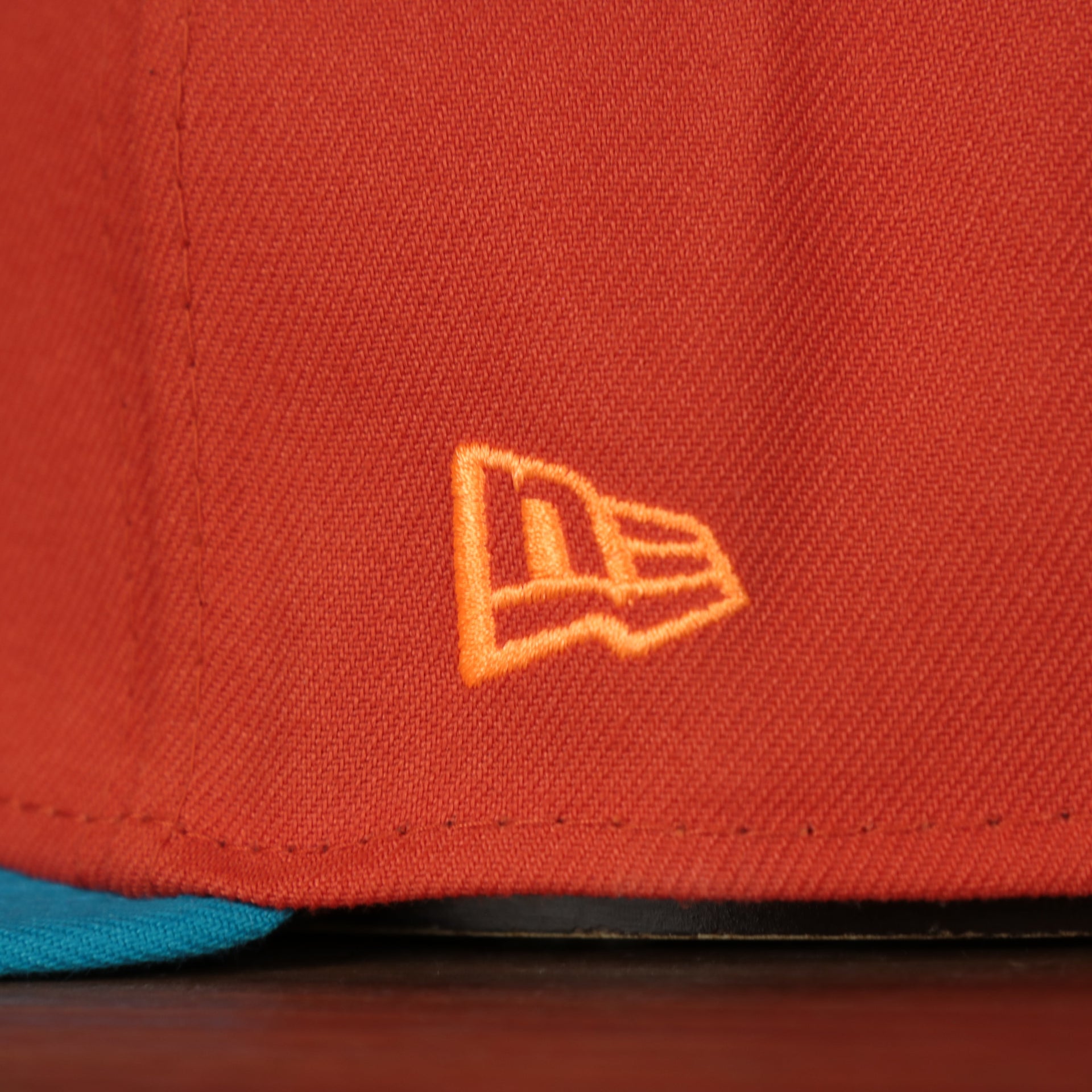 new era logo on the Wisconsin Timber Rattlers 2022 Cascabeles de Wisconsin Copa On-Field Black Bottom 5950 Fitted Cap | Orange