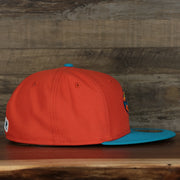 wearers right side of the Wisconsin Timber Rattlers 2022 Cascabeles de Wisconsin Copa On-Field Black Bottom 5950 Fitted Cap | Orange