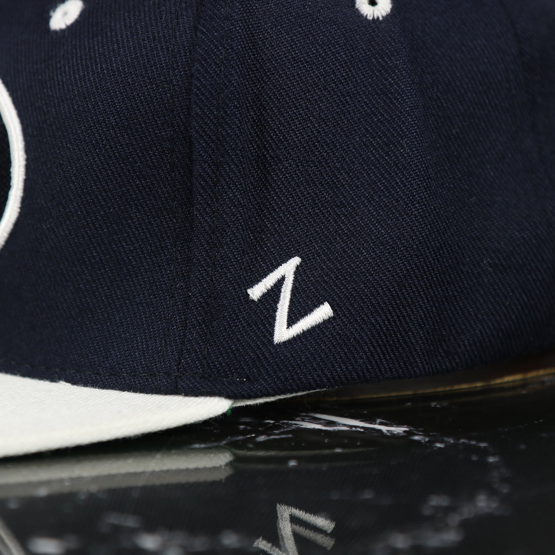zephyr logo on the BYU Cougars Green Bottom Arched Wordmark Snapback Cap | Navy Blue Snap Cap