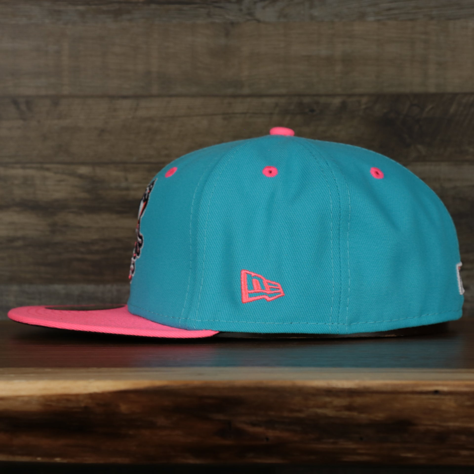 wearers left of the Leigh Valley Iron Pigs 2022 Coquis de Leigh Valley Copa de la Diversion On-Field Black Bottom 5950 Fitted Cap | Blue/Pink