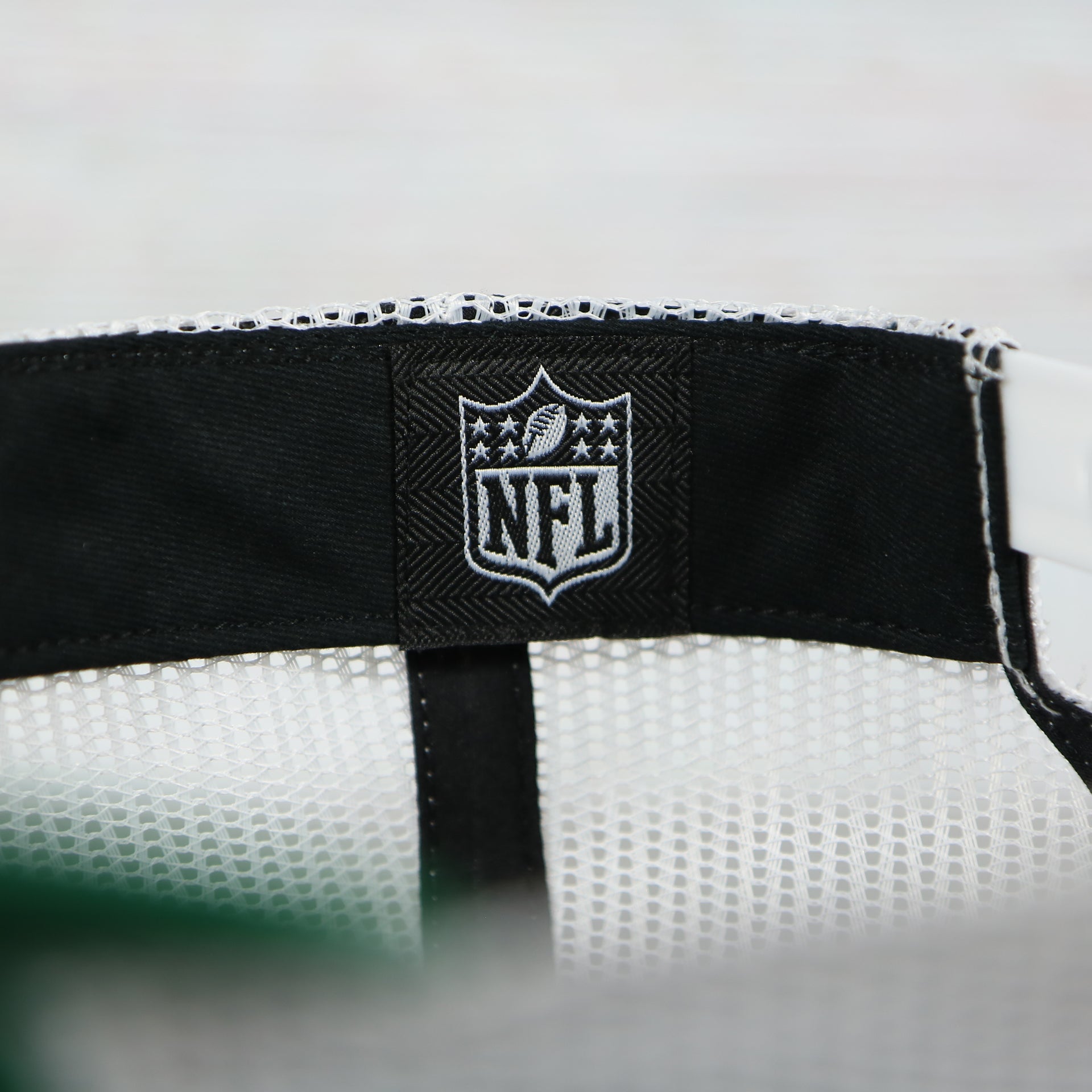 nfl logo tag on the Philadelphia Eagles Throwback Mesh Back Trucker Hat | Kelly Green Trucker Hat