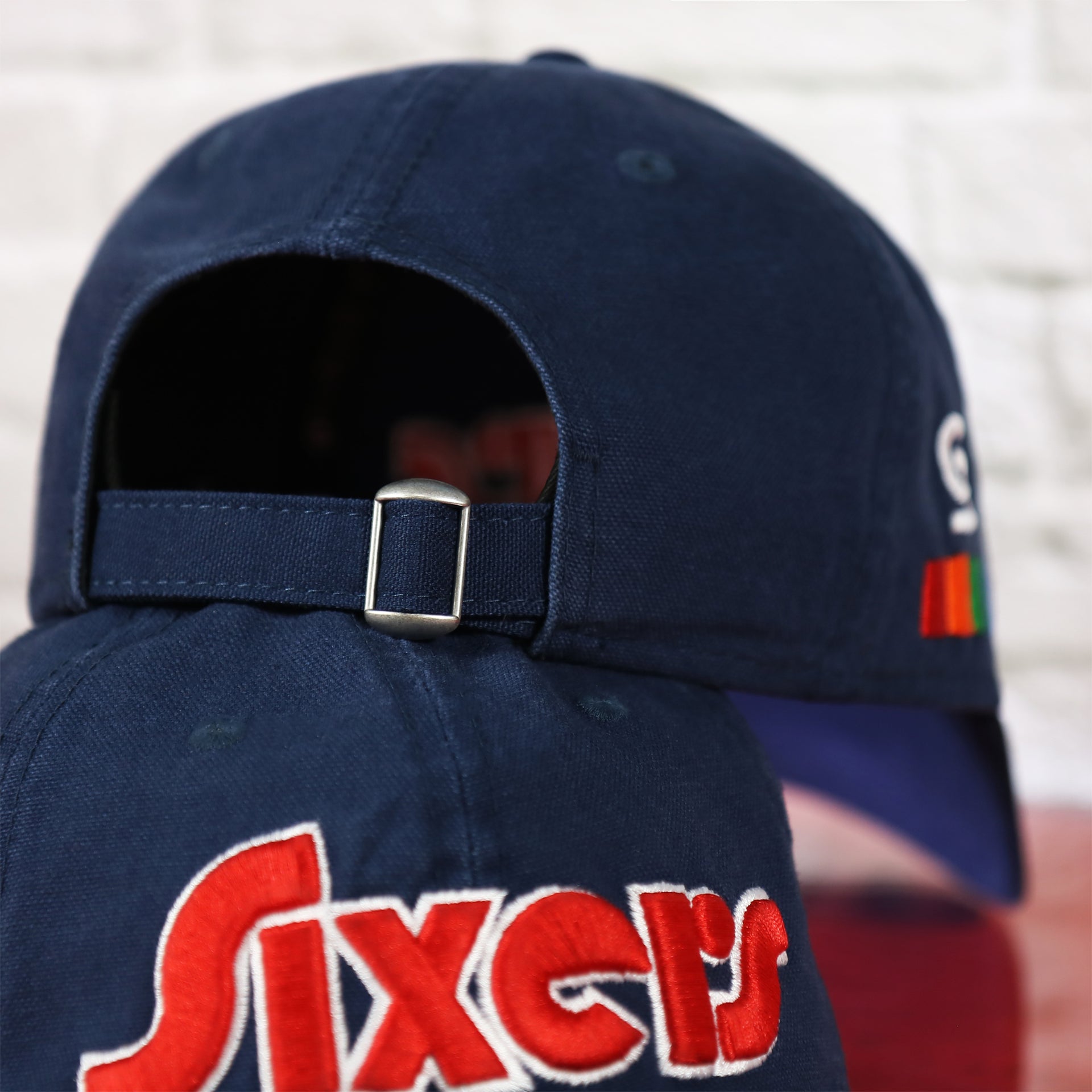 Adjustable strap on the back of the Philadelphia 76ers 2022 City Edition Sixers Script Spectrum Side Patch 9Twenty Dad Hat